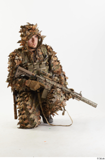 Frankie Perry in Ghillie kneeling with Gun holding gun kneeling…